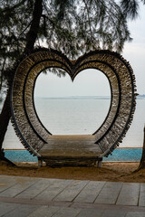 Heart-shaped wooden platform building on the beach by the sea