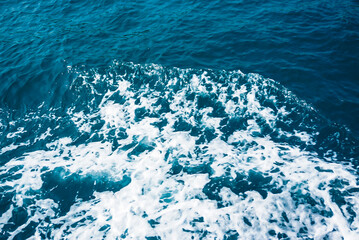 Creative blue water texture with a top view of sea waves.