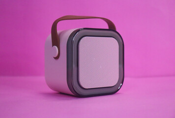 Small Speaker With Brown Hanging Belt On The Pink Background