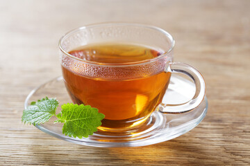 cup of tea with mint on wooden table