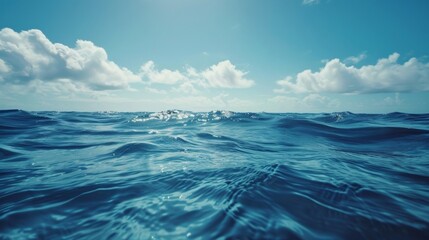 A body of water reflecting the sky above, with fluffy clouds floating in the blue sky. The scene captures the peacefulness of the water under the cloudy sky.