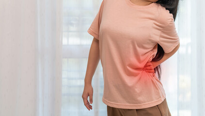 Woman unhappy holding back pain with suffering from painful shoulder, Upper arm pain, office...