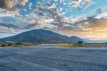 Asphalt road and mountain with sky clouds background at sunset - generative ai - obrazy, fototapety, plakaty