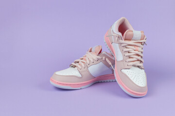 Elegant sports sneakers on a purple background.