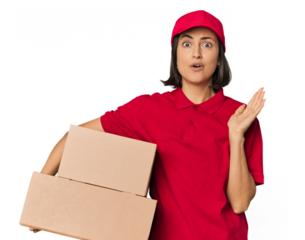 Young Caucasian delivery woman with boxes surprised and shocked.