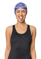 Young Caucasian female professional swimmer funny and friendly sticking out tongue.