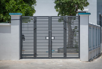 Modern panel housing gate in gray color. The entrance gate of the house