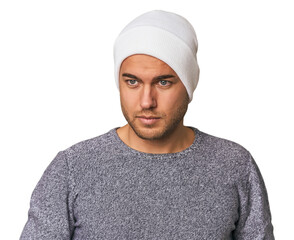 Close-up of a young man in a wool hat, showcasing winter fashion