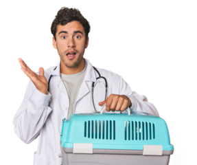 Young Hispanic man as vet with cage surprised and shocked.