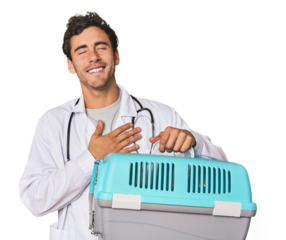Young Hispanic man as vet with cage laughs out loudly keeping hand on chest.