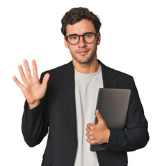 Young Hispanic businessman with laptop smiling cheerful showing number five with fingers.