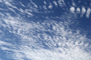 Pattern of white clouds against a blue sky abstract textured background
