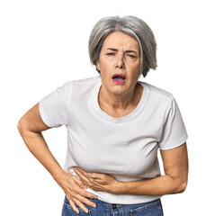 Caucasian mid-age female on studio background having a liver pain, stomach ache.
