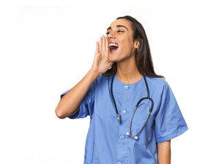 Hispanic nurse in uniform with stethoscope shouting and holding palm near opened mouth.