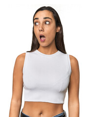 Hispanic young woman being shocked because of something she has seen.