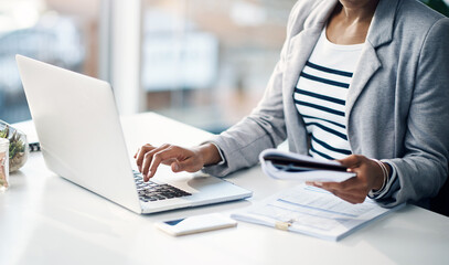Woman, hands and laptop with documents for finance, budget planning or accounting at office....