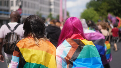 Happy lesbian couple walk lgbt pride. Two bi girl lovers go csd fest. Free same sex people coming...