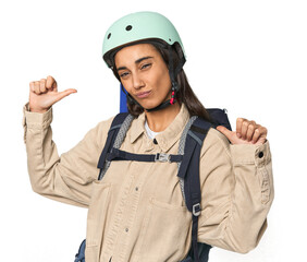 Hispanic young woman with mountain gear feels proud and self confident, example to follow.