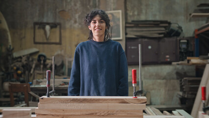 Woman carpenter portrait. Feminist girl process wood. Male carpentry work skill. Female joiner woodwork. Feminism worker smile. Person woodworker look at camera. Diy master class workshop. Job project