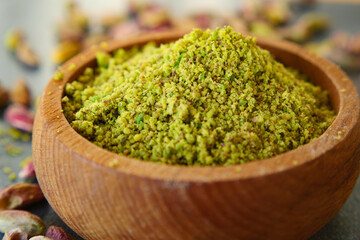 Wooden bowl filled with pistachios flour, a natural and nutritious superfood