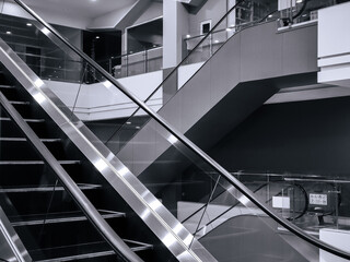 escalators in a building black and white