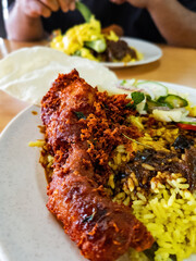 Nasi kandar the most popular dish in Penang, Malaysia. White rice with okra, curry sauce and fried chicken