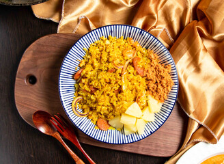 Pineapple Seafood Fried Rice with fork and spoon served in dish isolated on wooden board top view of asian food
