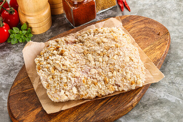 Breaded raw breaded meat schnitzel
