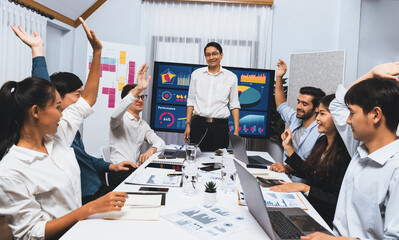 Analyst team leader celebrate with his colleague after successful data analysis meeting using...