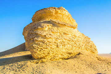 Abstract art shooting for Fayoum Rock Stone Desert, yellow sands and rocks, blue sky, photo is...