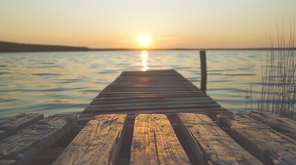Sunset solitude: A weathered dock juts out into the calm waters of the lake, offering a solitary retreat to watch the sunset. 