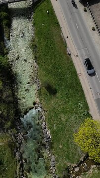 Bavarian Ramsau Berchtesgaden view along a church and icy cold mountain river with the Watzmann mountain chain at the background