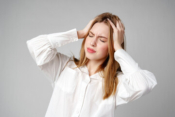 Woman With Hands on Head Suffering Headache
