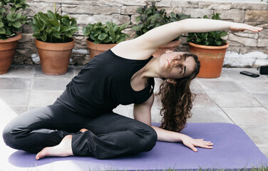 Fitness Enthusiast Performing Side Stretch in Outdoor Setting