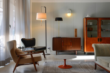 Contemporary Italian lamp alongside vintage furniture in a living room, emphasizing diverse design eras.