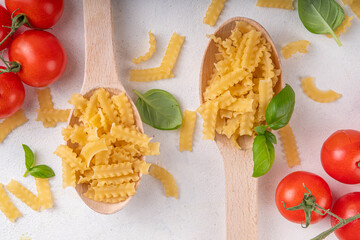 Raw Mafaldine pasta with ingredient for cooking