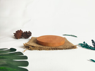 photography of circular wooden coasters with leaf ornaments on a white background suitable for mock-ups