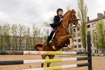 Front view of horse and rider executing jump.