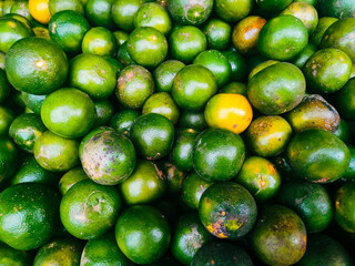 photography of close up texture background of pile of green orange fruit