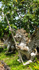 Bali MARCH 2024 - Stone sculpture of a beautiful winged dragon in Bali island, Indonesia. Hindu religious symbol.
