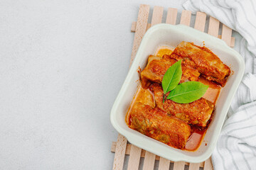 Cabbage rolls stuffed with rice and meat stewed in tomato sauce. Traditional dish, ready-to-eat food