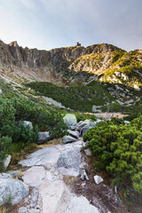 Hiking rocky path through the Krkonoše tundra on the Polish side of the mountains in a valley...