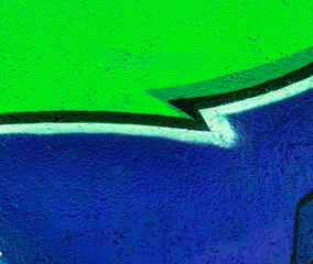 abstract and textured background of a colorful urban street wall with aerosol painted graffity pattern with concret texture