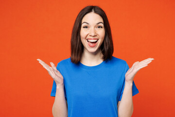 Young surprised shocked excited fun exultant woman she wear blue t-shirt casual clothes look camera...