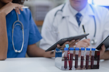 Scientist female African American doctor and doctor man working with test tubes in the laboratory.