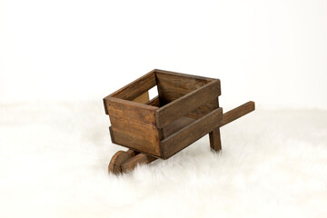 wooden wheelbarrow on white background