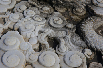 Vintage ornament on the stone. Close-up seamless texture. Stone texture. Embossed pattern.