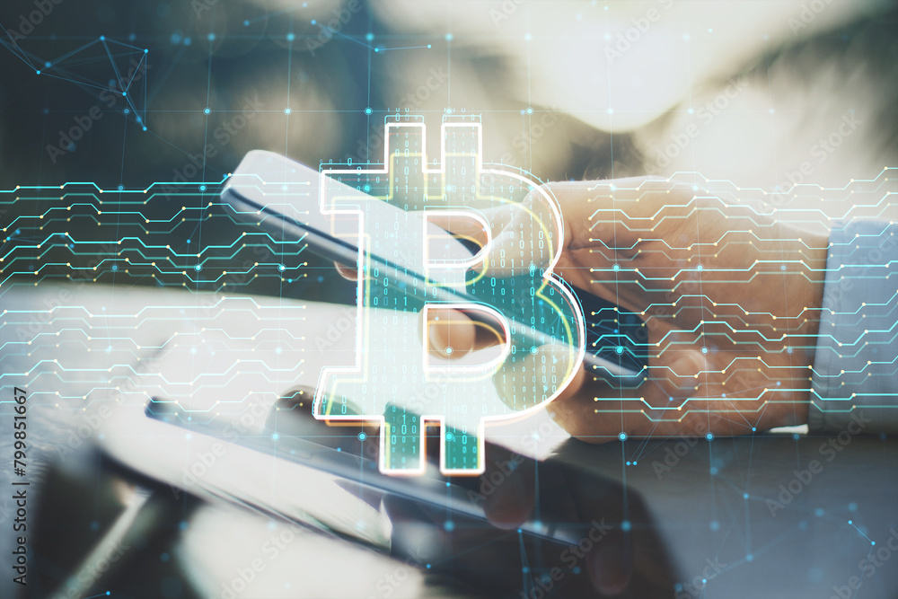 Poster close up of male hands at desk using smartphone with digital bitcoin sign and circuit on blurry back