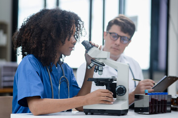 Medical science and microscope in laboratory for research concept. Two scientist with microscope...