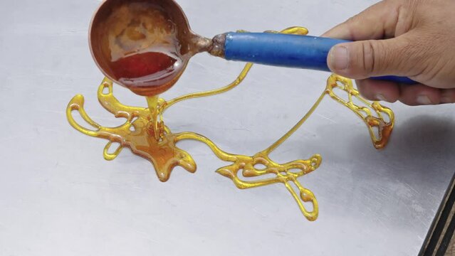 doing sugar painting shape like an ox, a traditional Chinese folk art using hot, liquid sugar